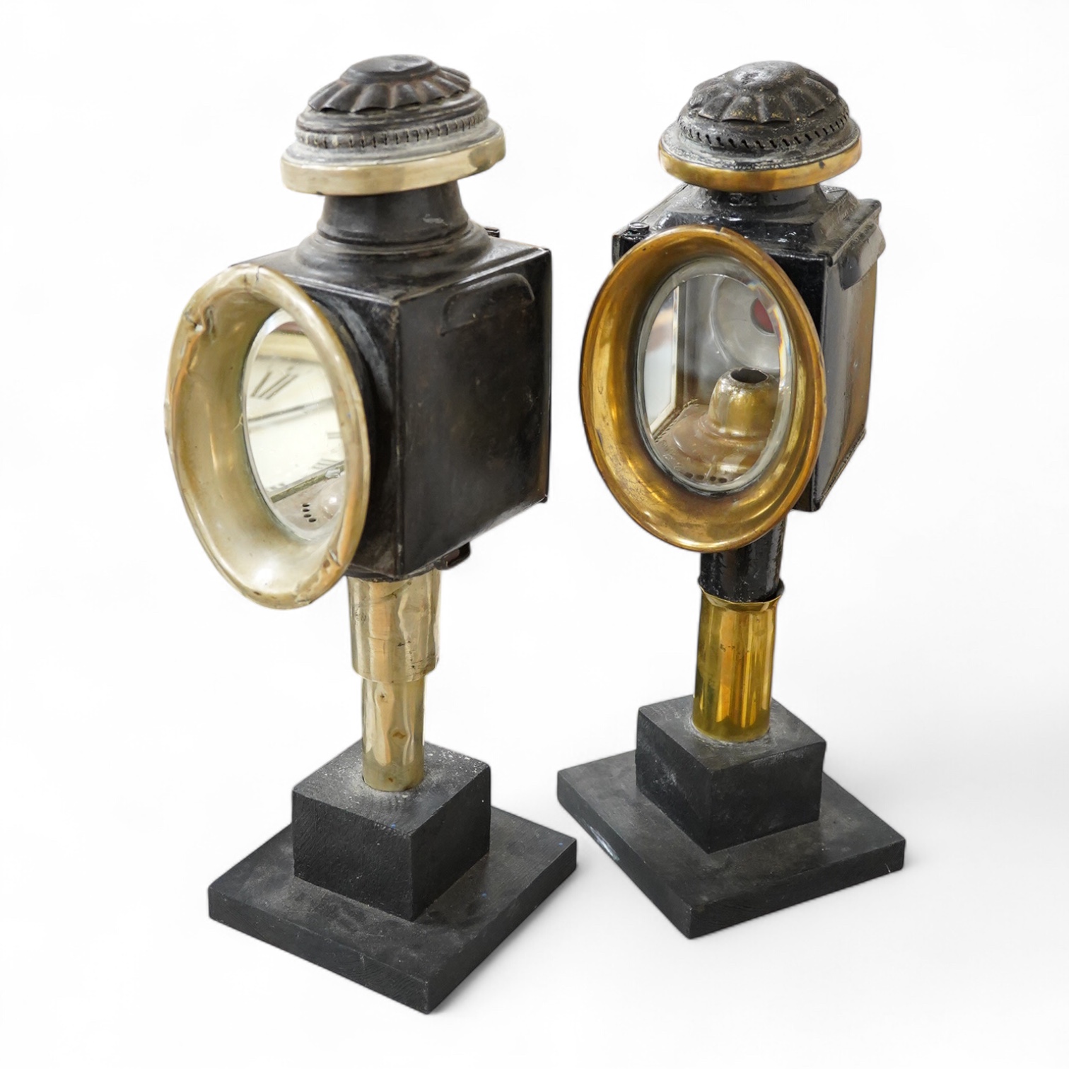 Two 19th century brass and painted steel carriage lamps, one by Raydyot with sprung ‘self adjusting’ candle holders, now mounted on modern painted pine bases for display purposes